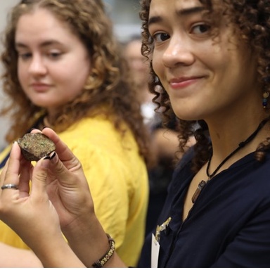 Jae Dancer holds section of meteorite